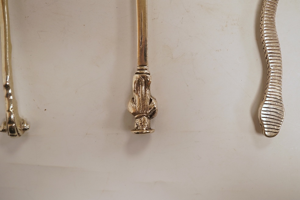 An 18th century silver apostle spoon, indistinct marks, 17cm, a continental white metal spoon with scroll handle and a pair of unmarked white metal spoons with serpent handles.